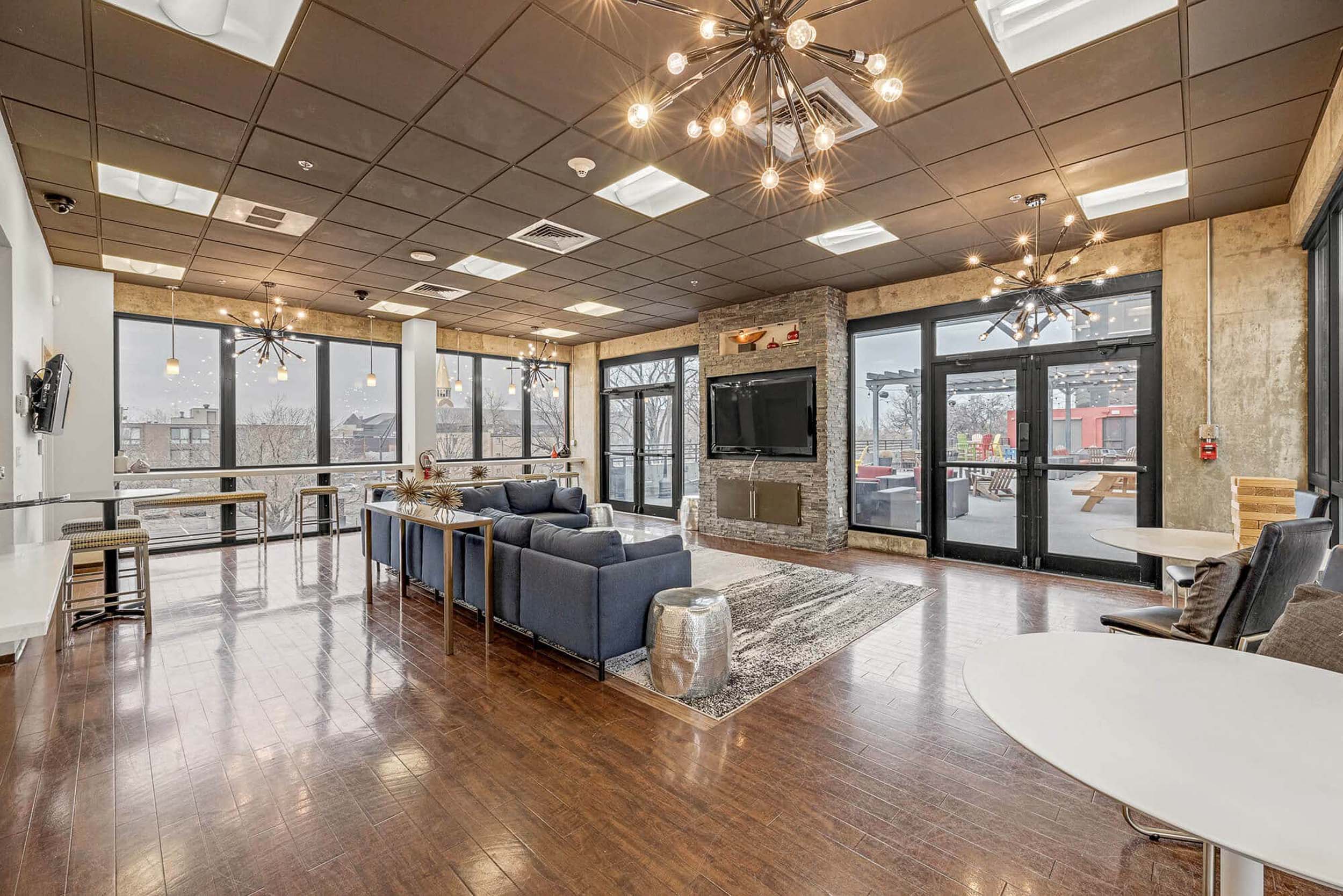 Bright clubroom area with sofa tables and seating in front of TV