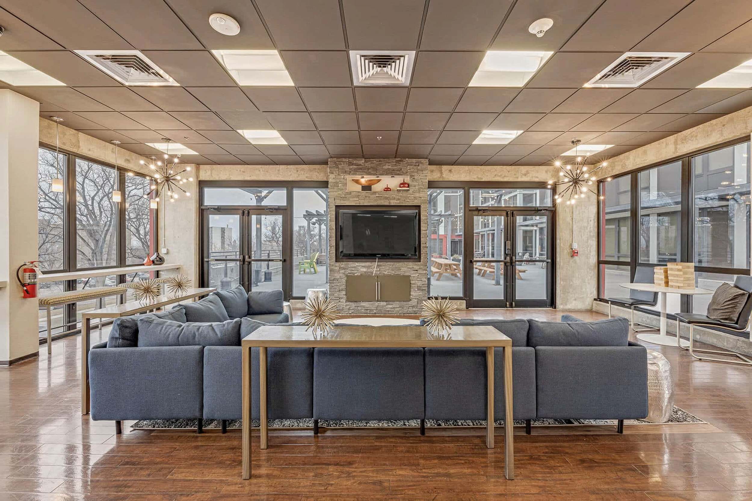 Clubhouse with blue sofa facing television and fireplace