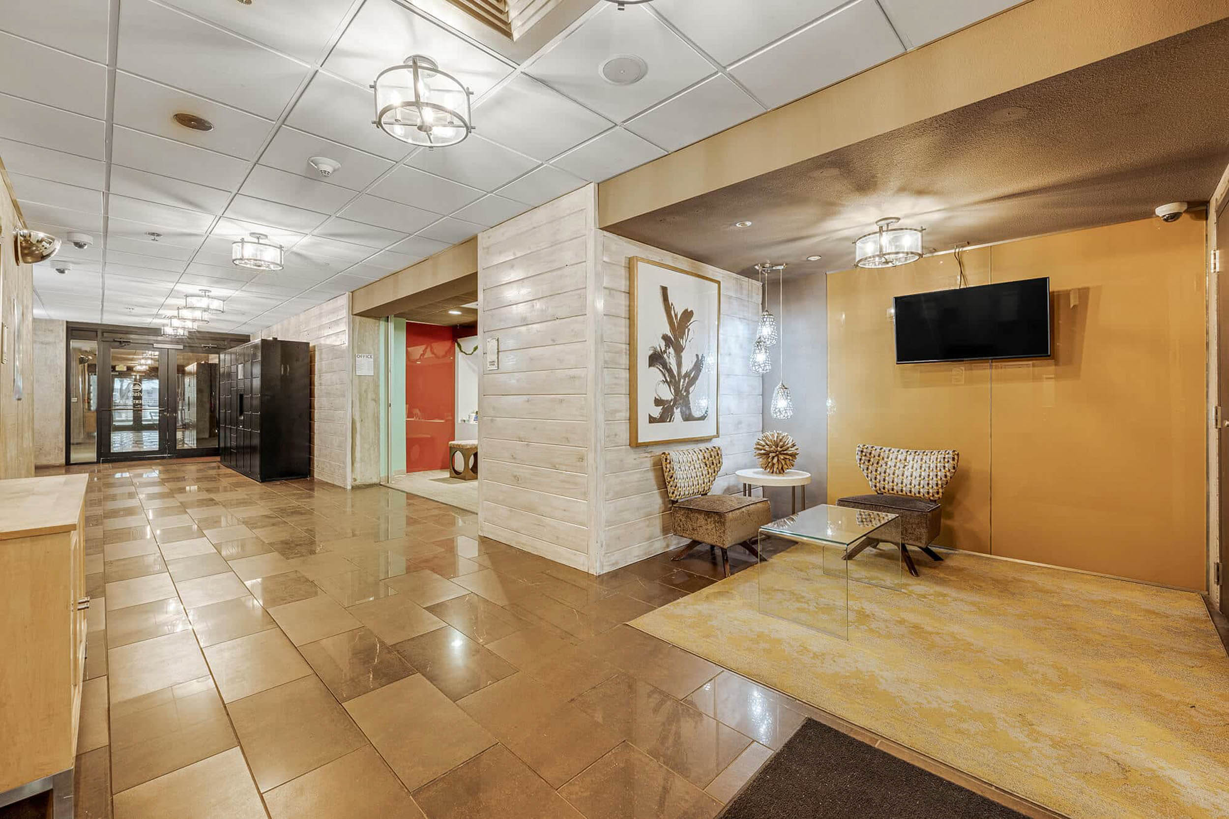 Community hallway area with seating office and amazon lockers