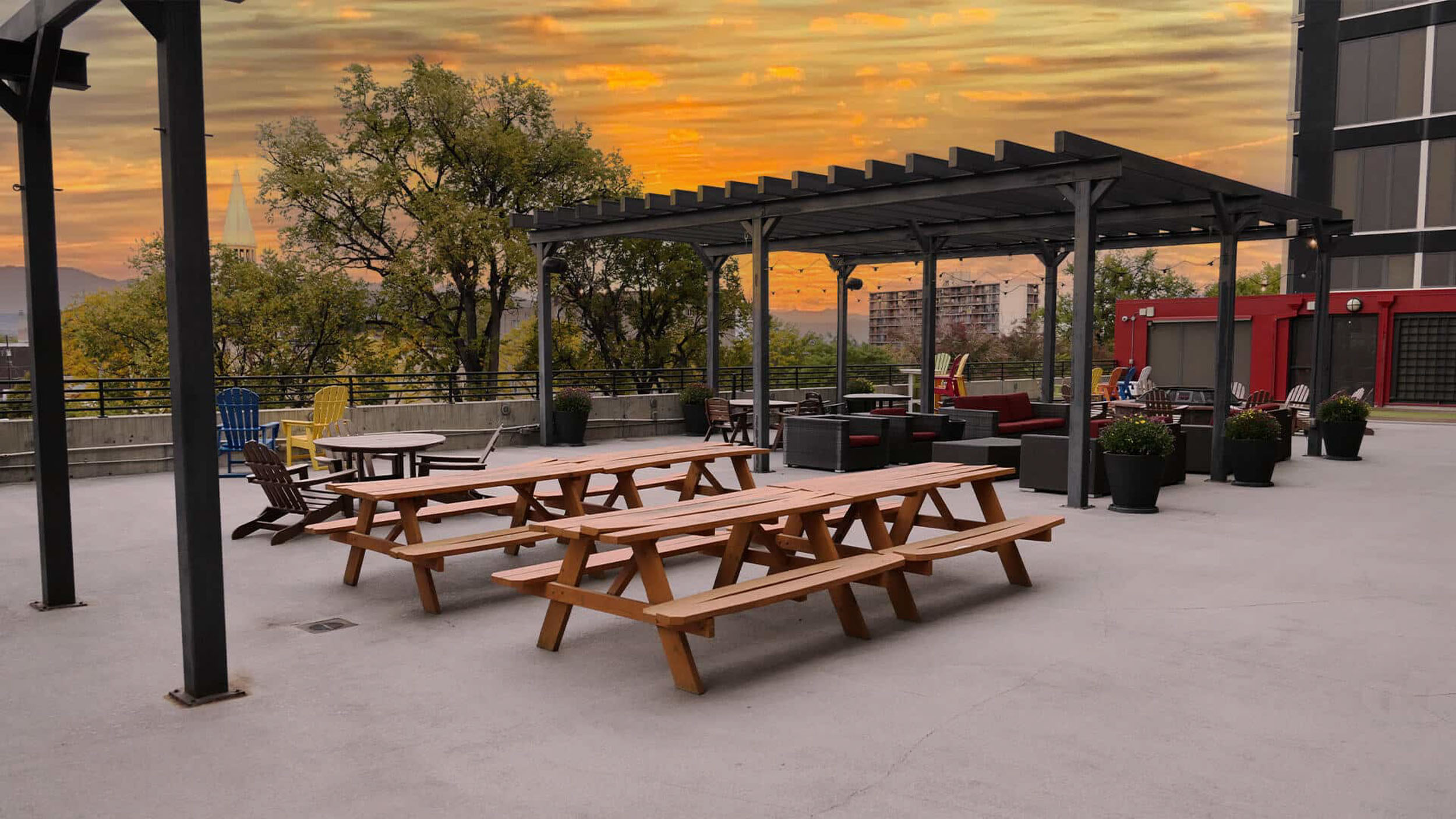 Outdoor courtyard with picnic benches and pergola lounge area