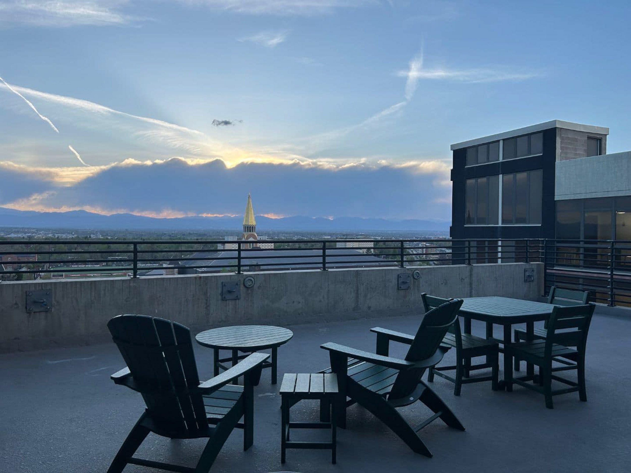 Rooftop lounge area with chairs and seating overlooking the city