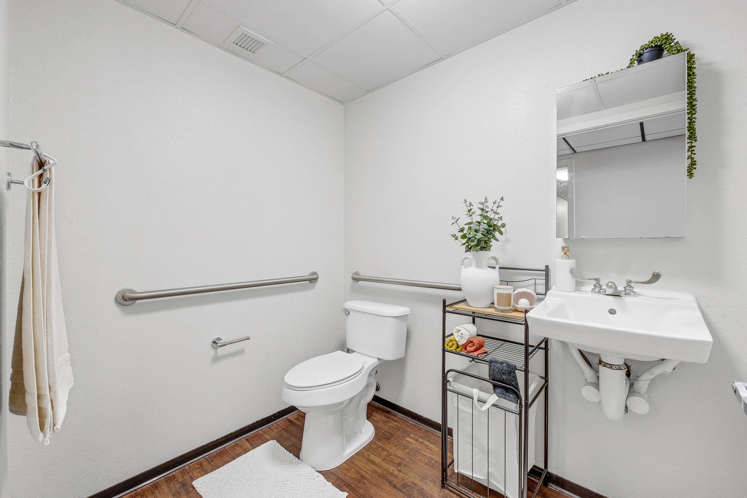 White bathroom with toilet vanity and storage